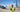 A surveyor standing in a construction site holding  survey pole